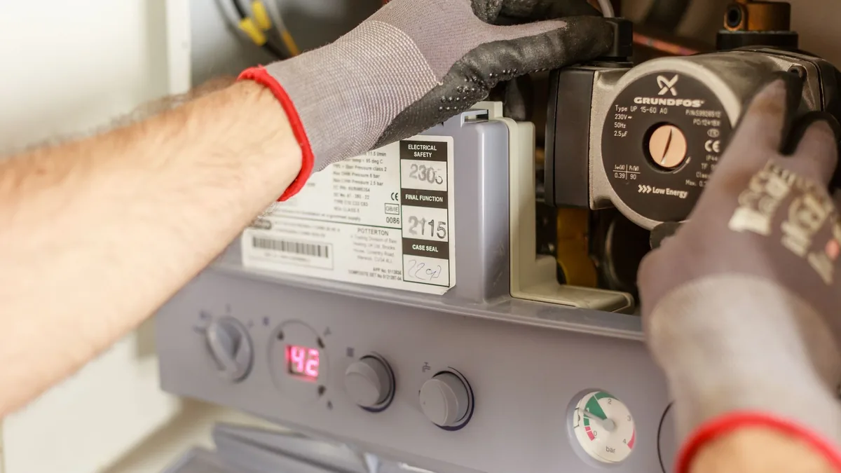 Technician replacing a residential boiler
